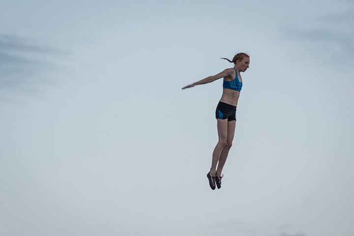 Delaney Miller jumps from the top of the Psicocomp wall. Photo: Justin Roth / Petzl